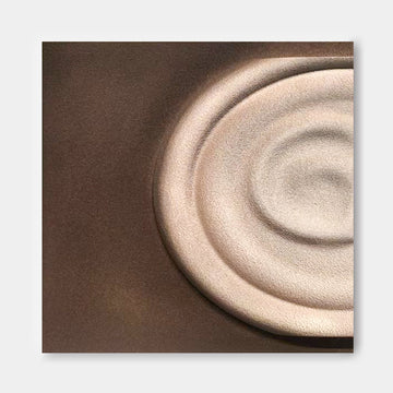 a close-up view of a circular object, possibly a plate or a bowl, with a textured surface.