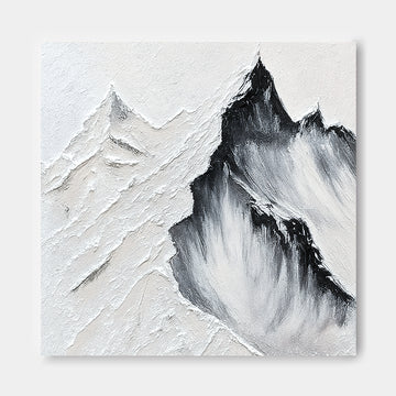 a striking black and white landscape featuring a dramatic mountain range with jagged peaks and a textured, rocky surface.