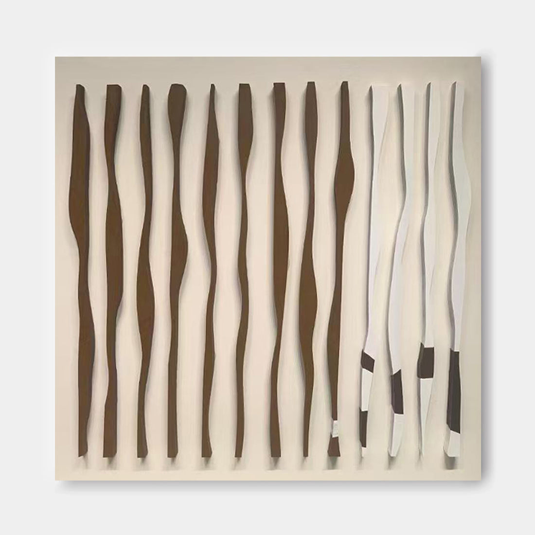 a series of abstract sculptures or artworks, each with a unique shape and color. The sculptures are arranged in a grid-like pattern, creating a visually striking display.