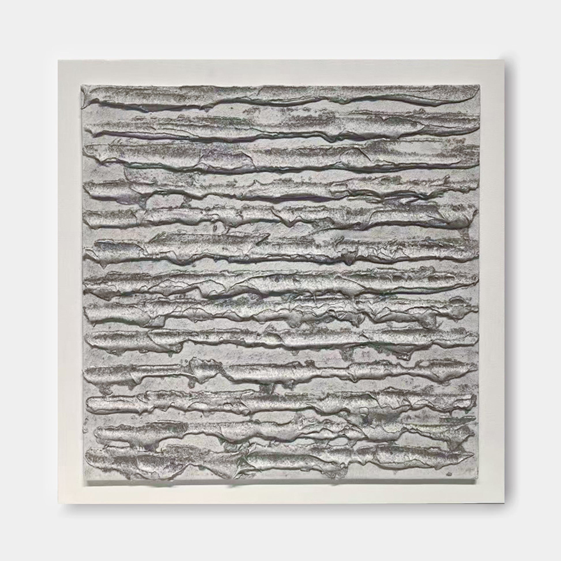 The image is a square-shaped abstract artwork with a textured, metallic appearance. The artwork features a repeating pattern of lines and curves, creating a sense of movement and depth.