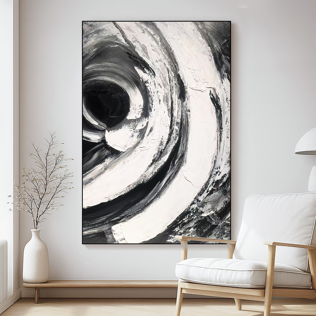 The image is a striking abstract painting with bold, swirling brushstrokes in black and white, creating a sense of movement and energy.