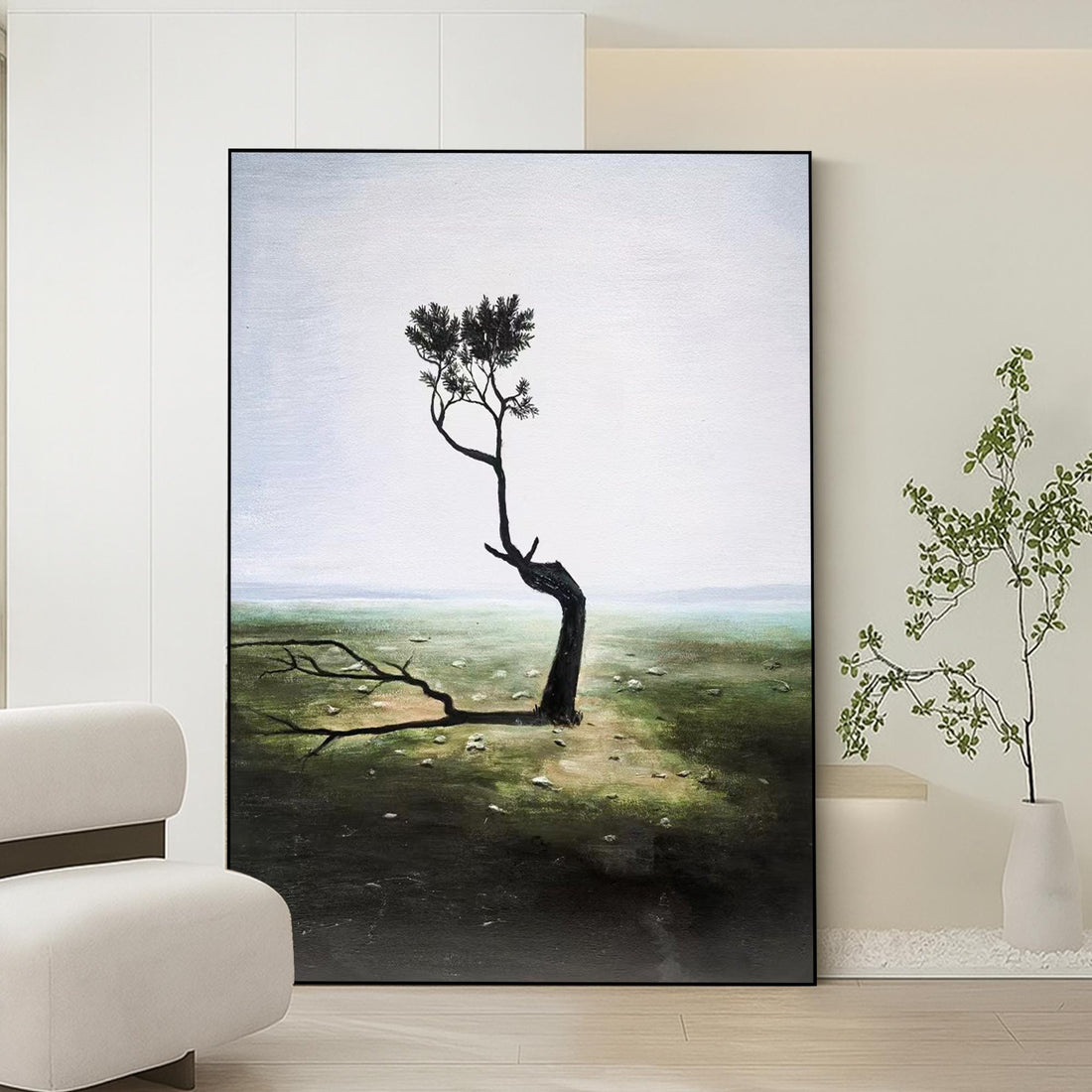 a lone, twisted tree standing in a barren, grassy field with a hazy, overcast sky in the background.
