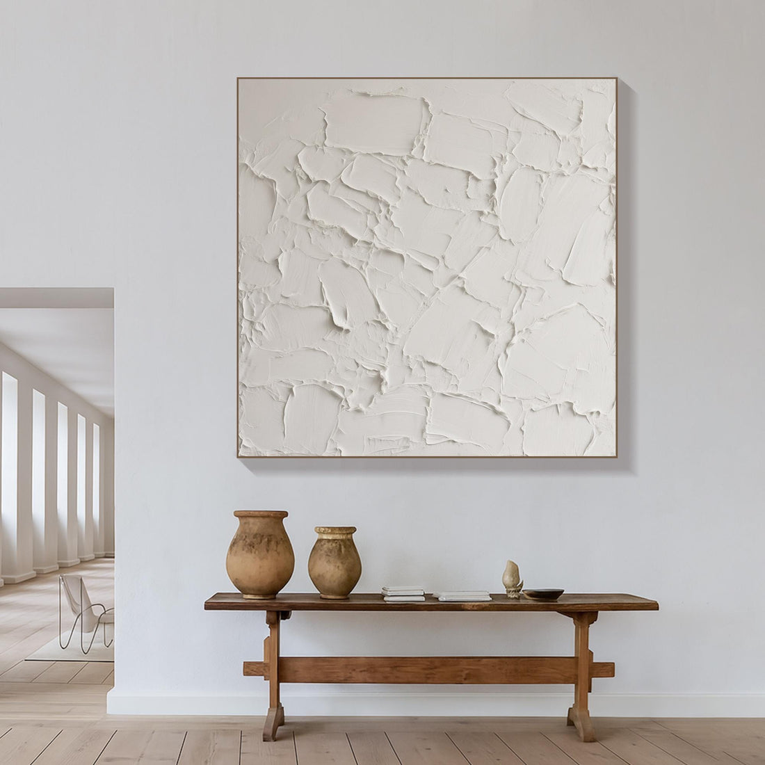 The image is a plain white surface with a textured, uneven appearance, resembling a wall or a canvas.