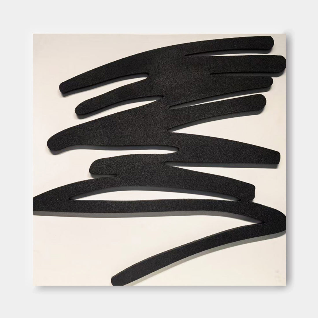 The image is a black and white abstract artwork consisting of various shapes and lines, including curved, jagged, and intersecting forms.