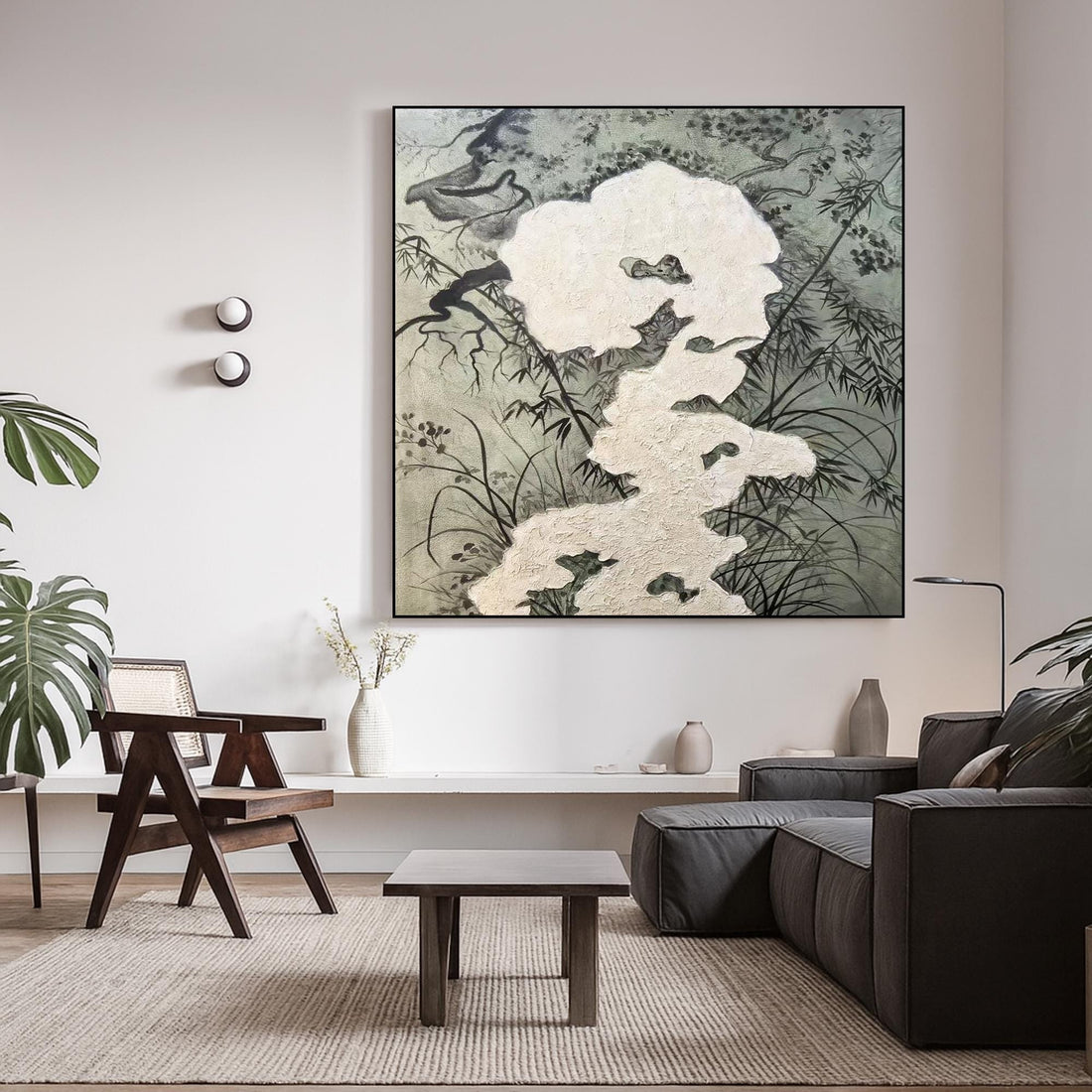 The image is a black and white abstract artwork featuring a large, white shape surrounded by various organic elements such as leaves, branches, and flowers.