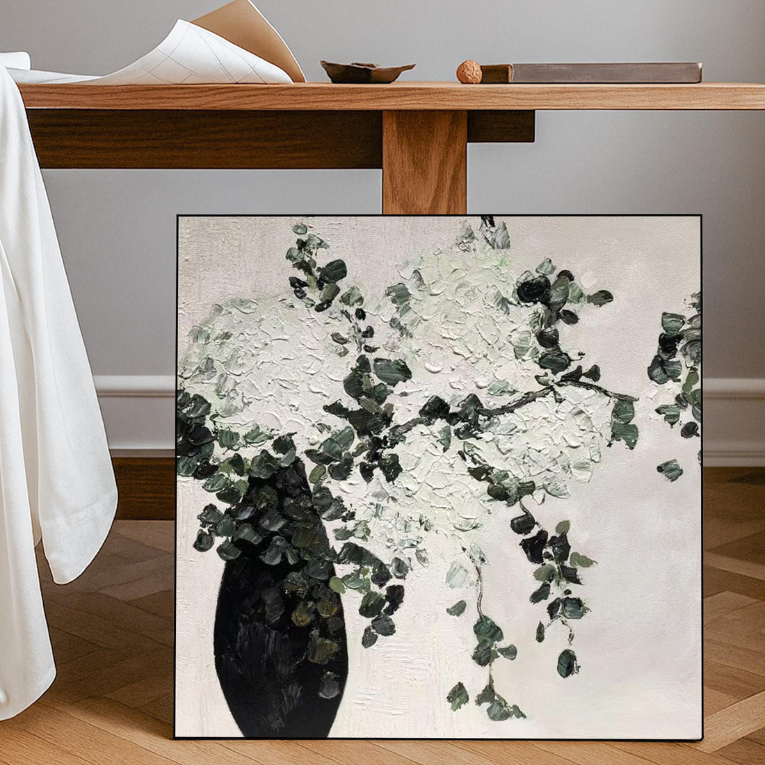 The image is a painting of a vase filled with white flowers and green leaves.