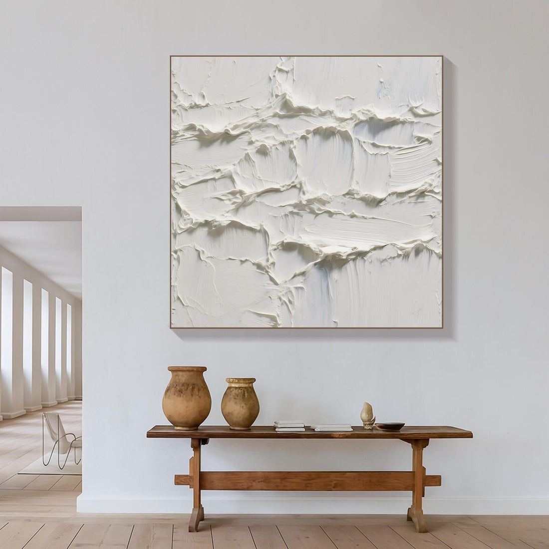 The image is a square painting with a textured, white surface that appears to be made of a thick, creamy substance. The painting has a rough, uneven texture, giving it a somewhat abstract and organic appearance.
