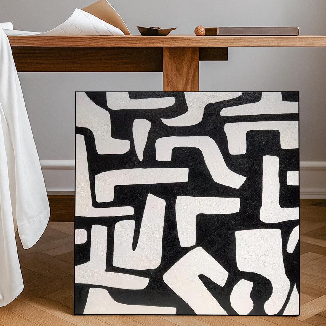 The image is a square with a black and white abstract pattern composed of various shapes and lines.
