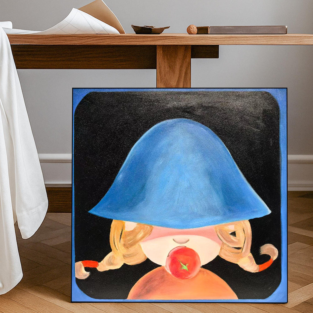 The image is a painting of a young girl wearing a blue hat, with a red apple in her mouth.