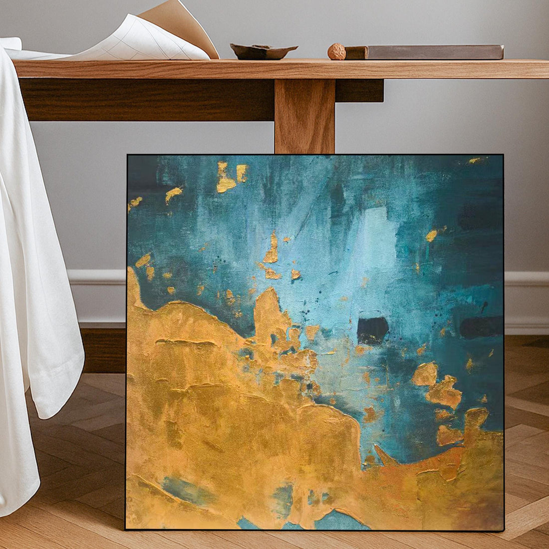 The image is an abstract painting with a mix of blue and gold colors, featuring a textured and layered appearance.